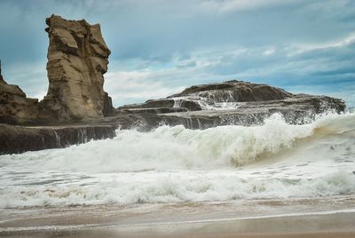 Scenic view of rock formations on beach