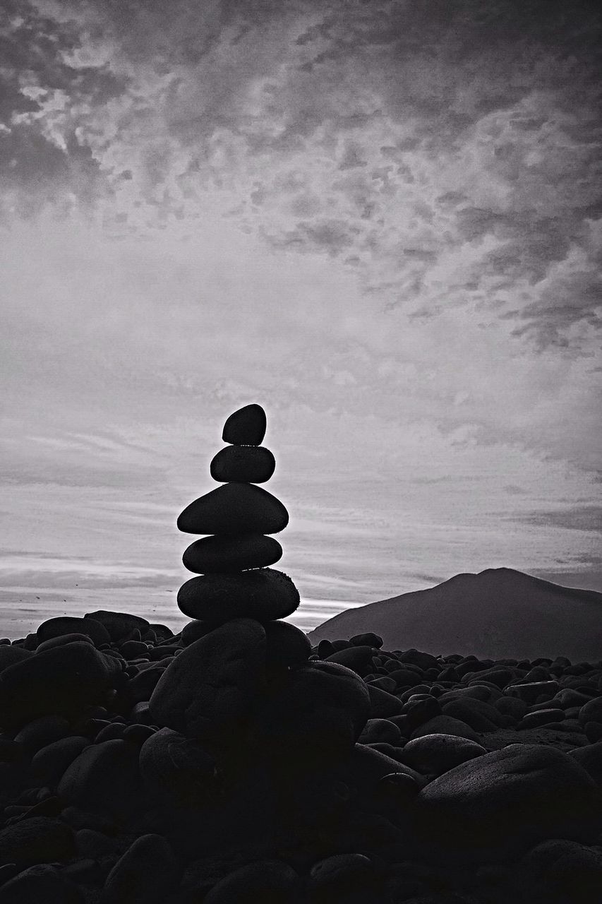 sky, rock - object, tranquility, cloud - sky, mountain, tranquil scene, stack, nature, scenics, stone - object, human representation, religion, outdoors, spirituality, beauty in nature, landscape, built structure, dusk, stone material