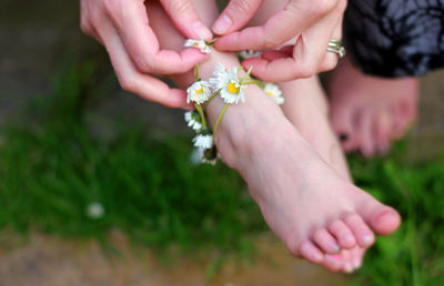 Midsection of woman holding fresh flower