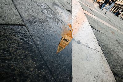Reflection of st marks campanile on wet street
