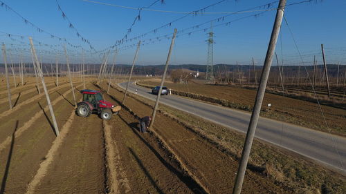 Road amidst agricultural field against sky