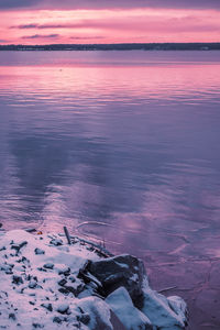 Scenic view of sea against dramatic sky during sunset