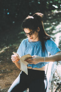 Young woman using mobile phone outdoors