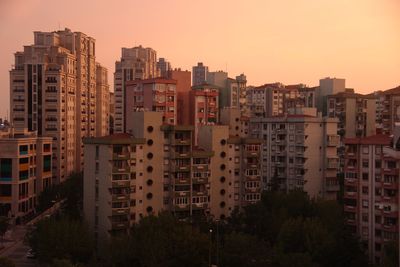 Cityscape against clear sky during sunset
