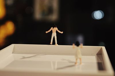 Close-up of figurines on tray