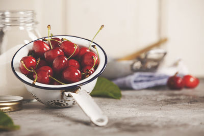 Close-up of cherries in bowl on table