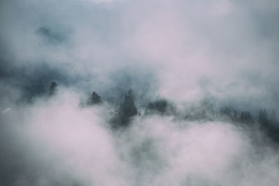High angle view of fog covered mountain against sky