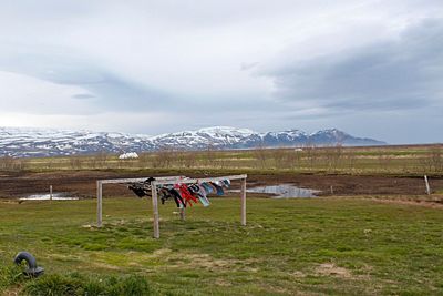 Scenic view of field and mountains against sky in island