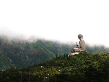 Buddha statue against mountains