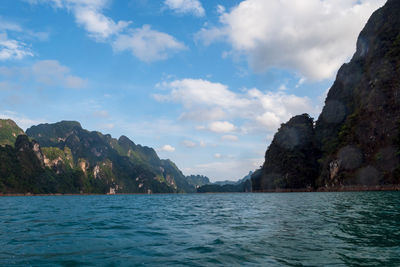 Scenic view of sea and mountains against sky