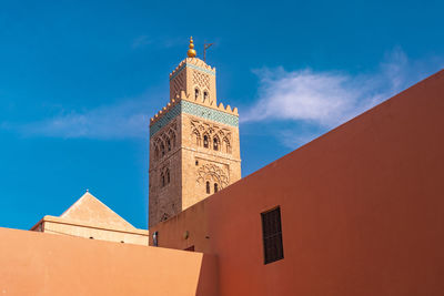 Koutoubia mosque minaret with blue sky and the orange walls