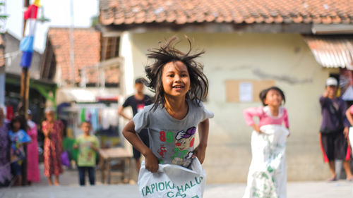 Portrait of a smiling young woman standing outdoors