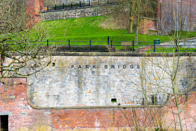 Text on wall by canal