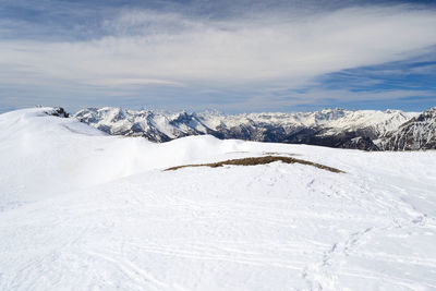 Scenic view of snow covered mountains against sky