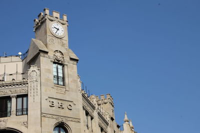 Low angle view of clock tower against sky