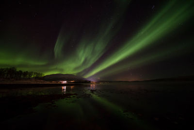 Scenic view of illuminated lights against sky at night