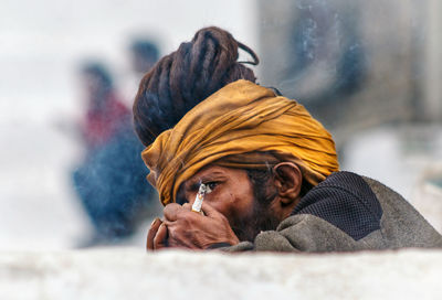 Close-up portrait of man with ice cream in winter