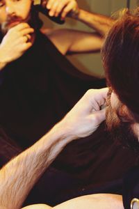 Close-up of bearded man shaving at home