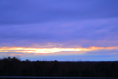 Scenic view of silhouette forest against sky at sunset