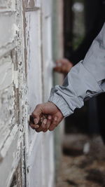 Cropped hands of people holding doorknobs
