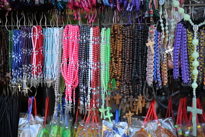 Multi colored decorations hanging in store for sale at market stall