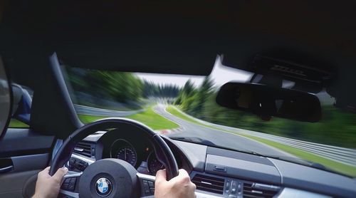 Close-up of hand on car windshield