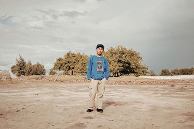 Full length of man standing on land against sky