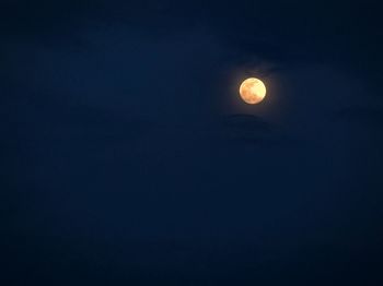 Low angle view of moon against clear sky at night