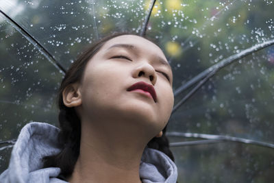 Portrait of young woman in rain