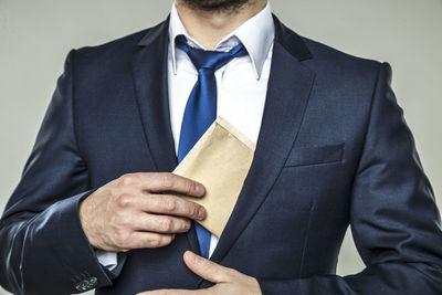 Midsection of man holding umbrella