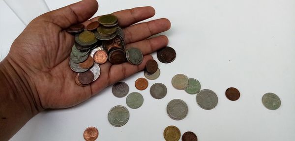 High angle view of hand holding coins