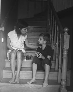 Full length of siblings sitting on staircase