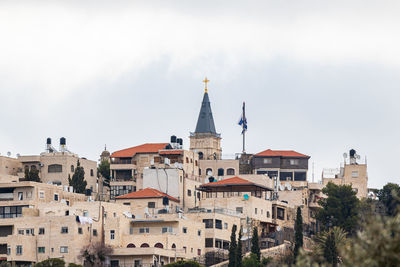 Low angle view of church in city against sky