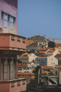Buildings in city against clear sky