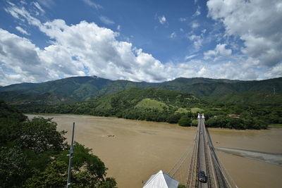 High angle view of road by mountains against sky