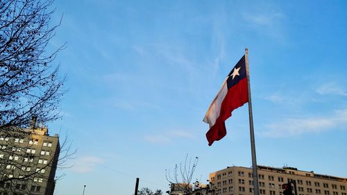 Low angle view of american flag against cloudy sky