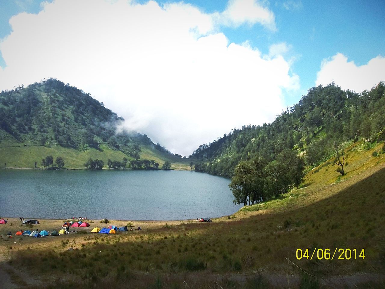 mountain, sky, water, scenics, tranquil scene, tranquility, tree, beauty in nature, mountain range, nature, lake, cloud - sky, landscape, grass, river, non-urban scene, green color, idyllic, cloud, day