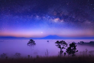 Scenic view of lake against sky at night