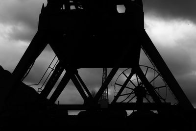 Low angle view of silhouette built structure against sky