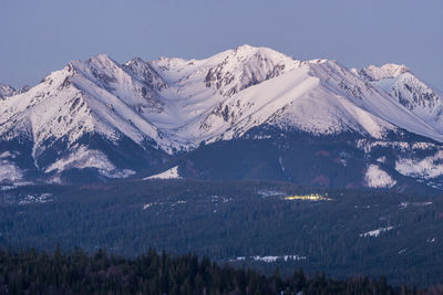 Scenic view of snowcapped mountains against clear sky