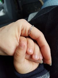 Close-up of couple holding hands