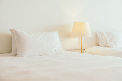 Pillows on bed in bedroom at home