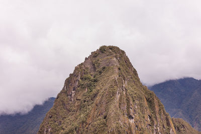 Scenic view of mountains against cloudy sky