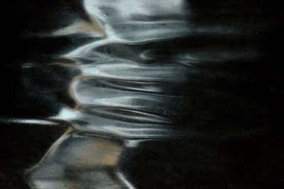 Close-up portrait of woman with reflection in water