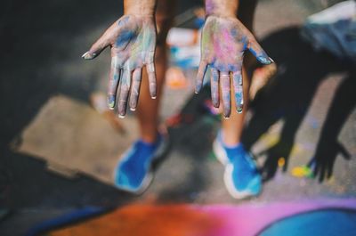 High angle view of human palm with holi colors