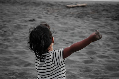 Rear view of girl on beach