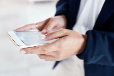 Midsection of businessman using mobile phone