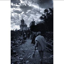 People in front of temple against sky