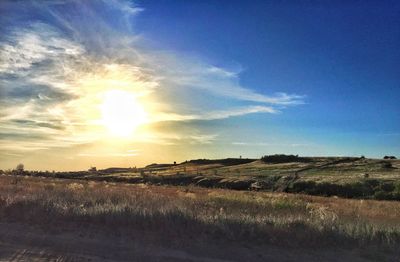 Scenic view of field against sky during sunset