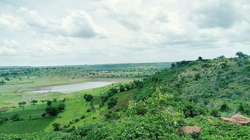 Scenic view of landscape against cloudy sky